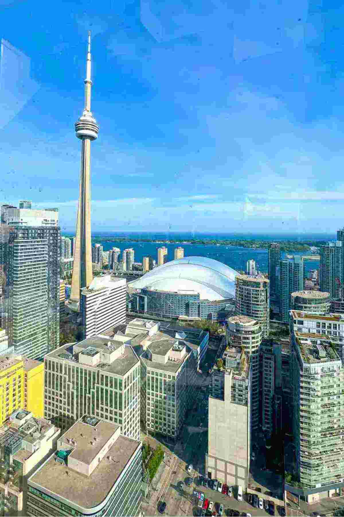Aerial view of Toronto cityscape featuring the CN Tower and the Rogers Centre.