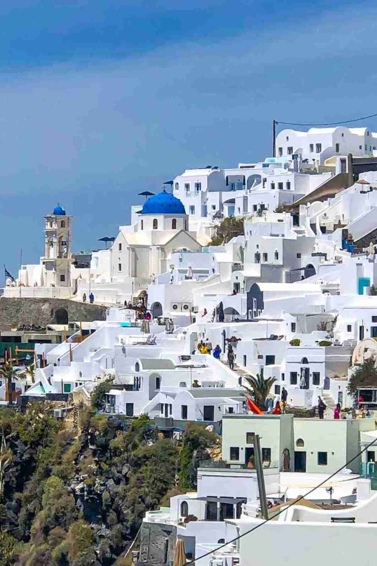 White buildings with blue domes, epitomizing the architecture of Santorini.
